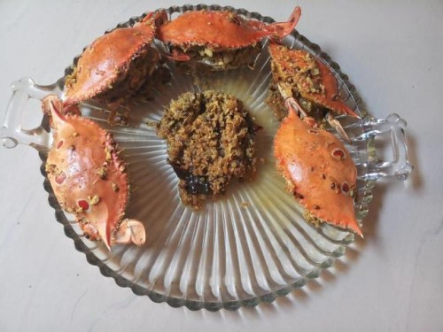 Ingredients :-

12 crabs nicely washed and cleaned.

Masala:
1 onion sliced one full coconut grated ,
6 khasmir and 3 guntoor chillies,
2tsp jeera 2tsp dhania ,
4 elaichi ,
4 cloves,
1 Cinnamon,
little poppy seeds,
2tblsp desiccated coconut.

Roast all this nicely. Allow to cool
In the mixer add the roasted Masala , add fresh cilantro, 2tsp of Reshampatty chillie pd, 12 flakes garlic, 1/4pc ginger grind to a fine paste.
We like it pungent.
Heat oil slice one onion fry nicely till pinkish add the masala fry well till it leaves a pleasant aroma. Leave it washed crabs and cook on low flame till it leaves the water. Then toss upside down add water and allow it to cook. U can add more water later if u want when the crabs are cooked well.

STUFFED CRAB

6 crabs cleaned and washed slightly opened for stuffing
Method for stuffing
Chop 4 onions fine
One coconut grated

Method:

Heat oil, add 2 tblsp coriander seeds, 1 tblsp jeera, add spices to your taste. Add pepper corn, Cloves, Cardmom, cinnamon, 3 Kashmir chillies, fry well add half tsp turmeric and fry well then add onions and coconut stir fry and allow to cool.
When it's cooled stuff ur crabs and cook in the same dish in which u prepared ur stuffing.
There will be little stuffing left cook ur crabs in it. At Least 15 min on low flame then add very little water and cook then slightly turn it crabs up down. Ensure that the crabs are well cooked.