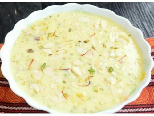 Recipe By supritee

BADAM KHEER....
¼ cup almonds or 35 almonds...
⅓ cup water for soaking...
¼ to ⅓ cup milk for grinding...
5 tablespoons sugar or add as required
4 chotti elaichi...
2.5 cups milk...
10 to 12 strands of Kosar...
Procedure:
Soak, blanch and peel almonds...
Take 3 to 4 of blanched almonds and slice them thinly...
add the remaining almonds in a grinder... add 5 tblsp sugar, seeds from 4 green cardamoms....
add ¼ to ⅓ cup milk... milk can be chilled or at room temperature... grind till smooth....the almonds should be ground very well to a smooth consistency....if there are coarse particles or chunks, then it can be irritating to the throat.....take 2.5 cups milk in a pan. make sure that the pan is large enough so that the milk does not spill out while boiling.... keep the pan on a low flame and begin to heat badam milk till it comes to a boil... stir at intervals so that the milk does not scorch from the bottom.... add saffron... simmer flame for 3 to 4 minutes.....do stir at intervals.... add the almond paste..... mix very well with a spoon..... let the entire badam kheer come to a boil.... switch off the flame... scrape the evaporated and dried milk at the sides of the pan and add them in the kheer....
serve badam kheer hot, warm or chilled.... garnish badam kheer with the sliced almonds and a few strands of saffron....