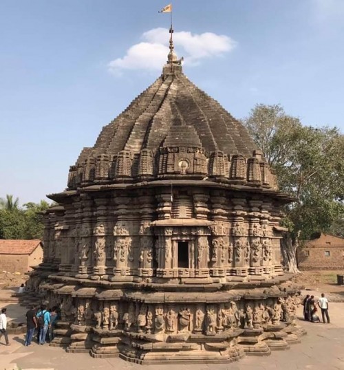 Narration by  Mr Ramesh Kabra


Hidden treasures of India as seen through my eyes: 

In an obscure Indian village in interior Maharashtra (65 kms from Kolhapur) adjacent to Karnataka border lies an ancient architectural treasure not much known to the world outside and yet to figure on the regular tourist map. Only serious lovers of Indian architecture & archaeology make an attempt to visit it and come back mesmerized with its craftsmanship - the exquisitely carved figures of Indian gods, goddesses, dancers, musicians, elephants etc. all around the temple in several layers leave you wonder struck. 
I am talking about the KOPESHWAR Mahadev Temple in the village called Khidrapur on the banks of river Krishna,  amidst rich sugarcane plantations. 
It is believed that the construction of the temple was started in the 8th century during the Satavahana period but remained incomplete. It was only in the late 11th & early 12th century during the reign of the Shilahara kings of Kolhapur region in particular Raja Bhoj II that the temple could be completed. 

The temple’s Shikhar has a distinctive style not seen in other temples. 
The temple has a unique feature that is never seen in any other Shiva temple. The sanctum sanctorum has two lingas and the temple does not have a Nandi. The first Linga represents Vishnu as ‘Dhopeshwar’ and the second Linga represents Shiva as ‘Kopeshwar’ !!! 

The mythological story associated with it goes as follows: on learning about the death of Sati at her father’s yagna, Shiva became furious & enraged (Kop), the devtas got scared as they feared that Shiva would destroy all the worlds. They requested Vishnu to do something. After much cajoling, Vishnu managed to bring Shiva to Khidrapur and somehow managed to wash (dho) away his anger there. Hence Shiva is depicted as Kopeshwar and Vishnu as Dhopeshwar. Strange isn’t it ??? The reason why no Nandi can be seen is because Sati had gone to her father’s place riding on Nandi. So Nandi was not with Shiva at that time !!! 

The highlight of the temple is the Swargmandap that has 48 pillars and not two pillars are alike and the ceiling of the swargmandap is open to the sky. The reason ascribed for it is that the mandap was used for performing yagnas & havans so the smoke of the havan could escape through the open ceiling without discomforting those present inside !! 

This temple is an architectural marvel -several layers of exquisite carved sculptures all around the exterior wall of the temple leave the visitor wonderstruck & mesmerized. It seems as if you are reading a poetry in stone and after reading every line you involuntarily say wah !! One can spend an entire day gazing at them !!! 
There are friezes of gods & godesses including Shiva, Parvati, Vishnu, Brahma, Durga, Ganesh etc., celestial maidens in different poses, mythological beasts etc. There are elephants all around the temple at the lower level and the gods are seen riding them. It seems as if the weight of the entire temple is being carried by these elephants. Trunks of all the elephants except two or three have been destroyed during attack on the temple.